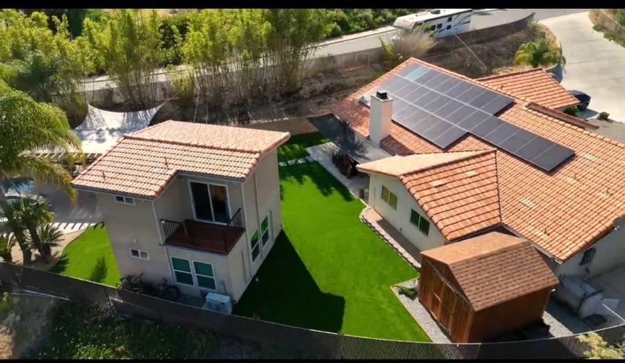 Aerial view of two properties with turf yards
