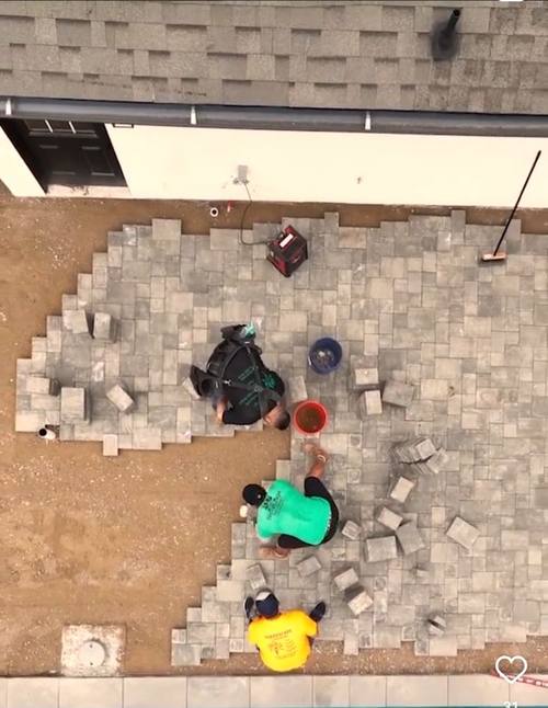 Drone shot of crew laying pavers